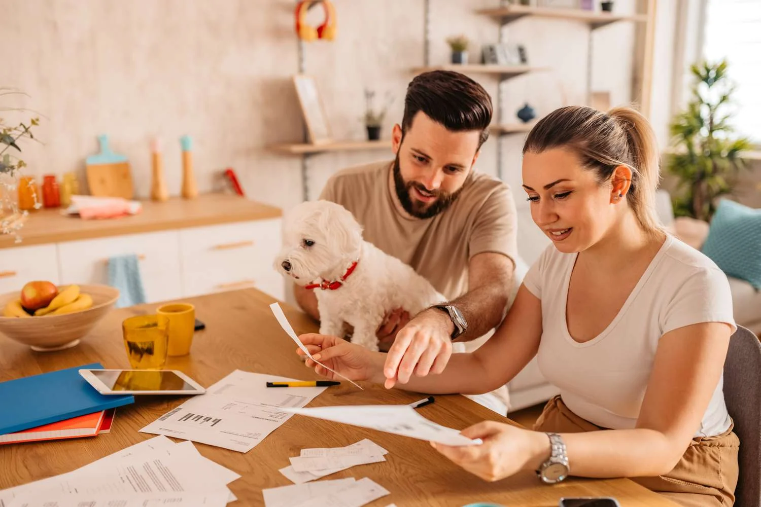 Pet owners reviewing household costs and pet insurance